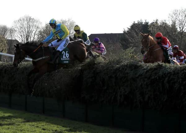 Danny Cook and I Just Know in the air at Becher's Brook before coming to grief on landing.