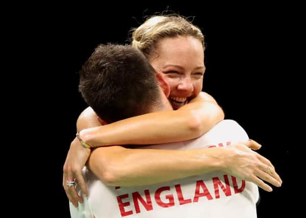 England's Chris Adcock and Gabriell Adcock celebrate victory.