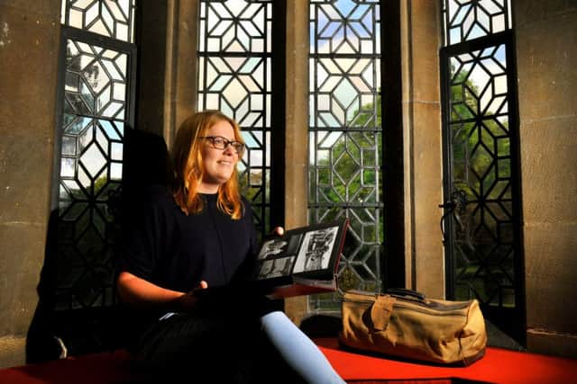 Beccy Roberts  Visitor Experience Officer at Goodards  in York looking through Betty Terry's  photo album alongside her old gym bag (1930-40's)  at  Goddards  in York for the first  Find Out Friday event this Friday.