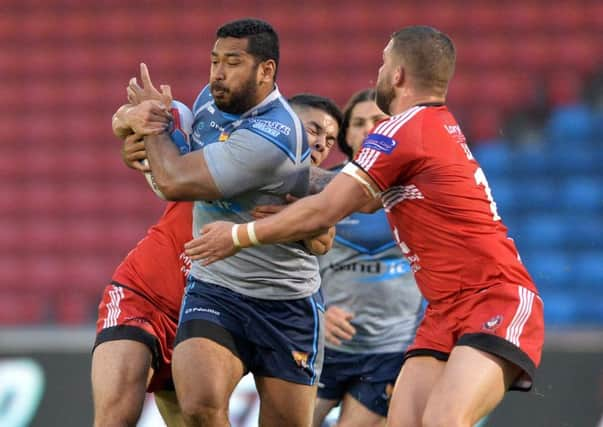 Huddersfield Giants' Seb Ikahihifo is held by Jake Shorrocks and Ryan Lannon during his side's win over Salford Red Devils (Picture: Bruce Rollinson).